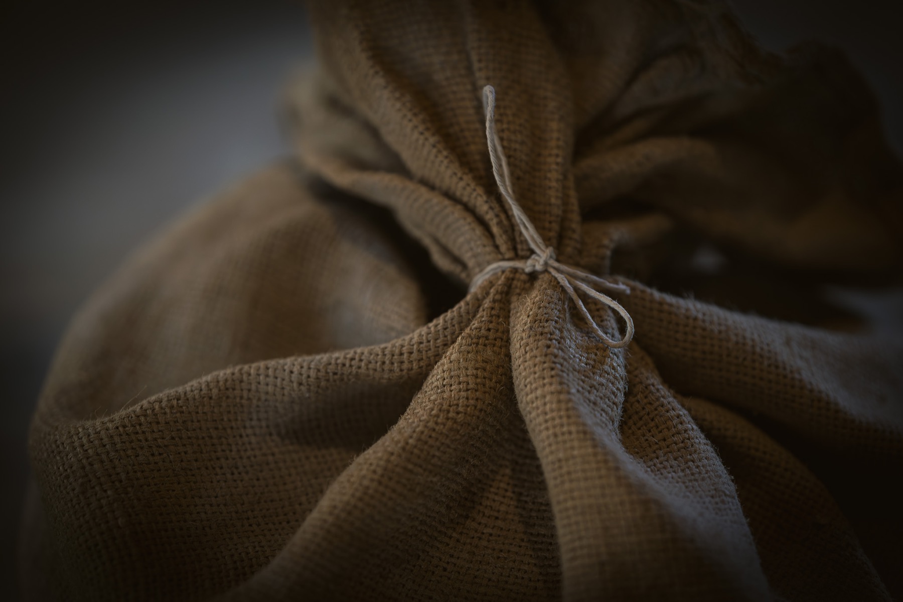 A sack of grain resting on the wooden floor inside Cogglesford Mill.