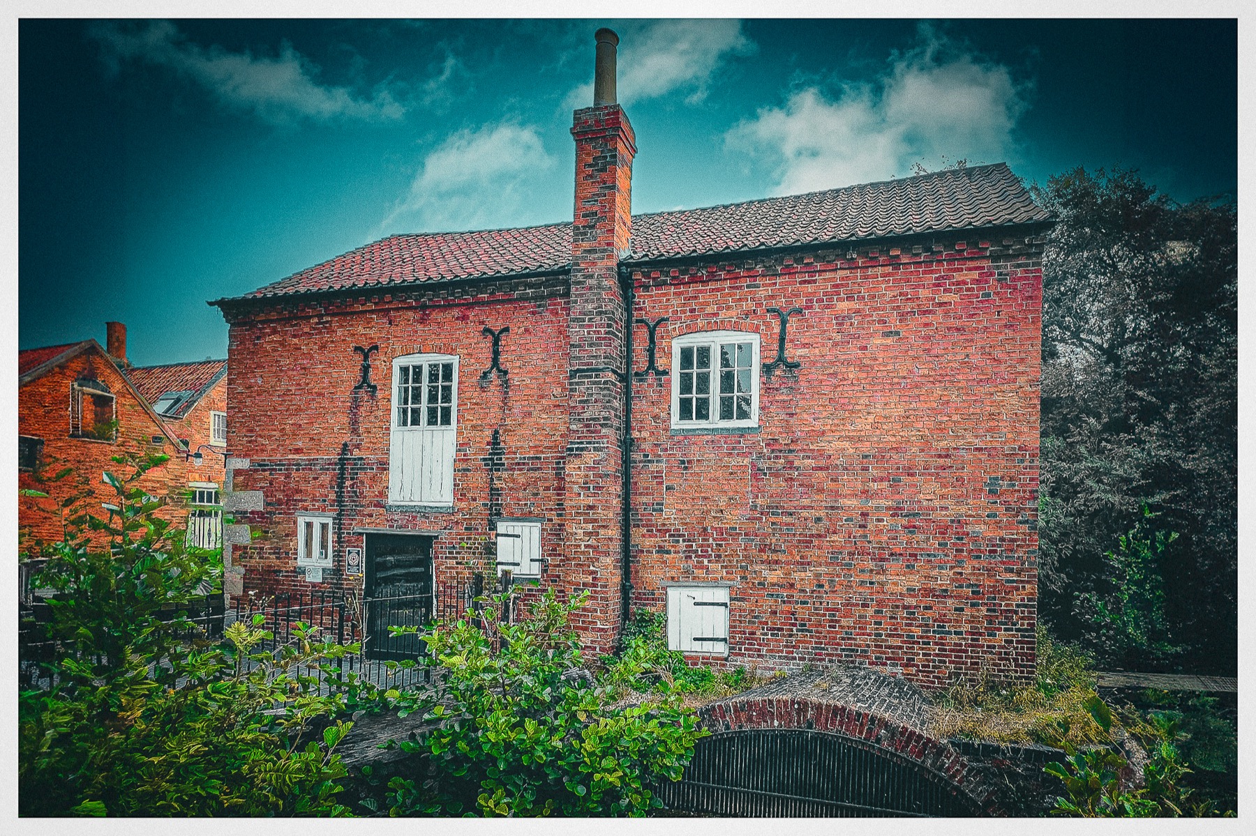 Cogglesford Mill caught in soft light beside the River Slea.