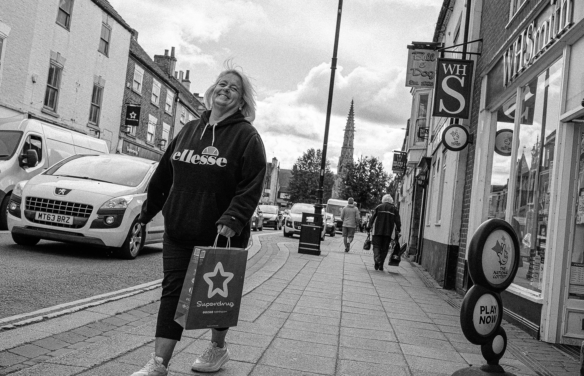 Shopper walking down Sleaford Southgate near WH Smith