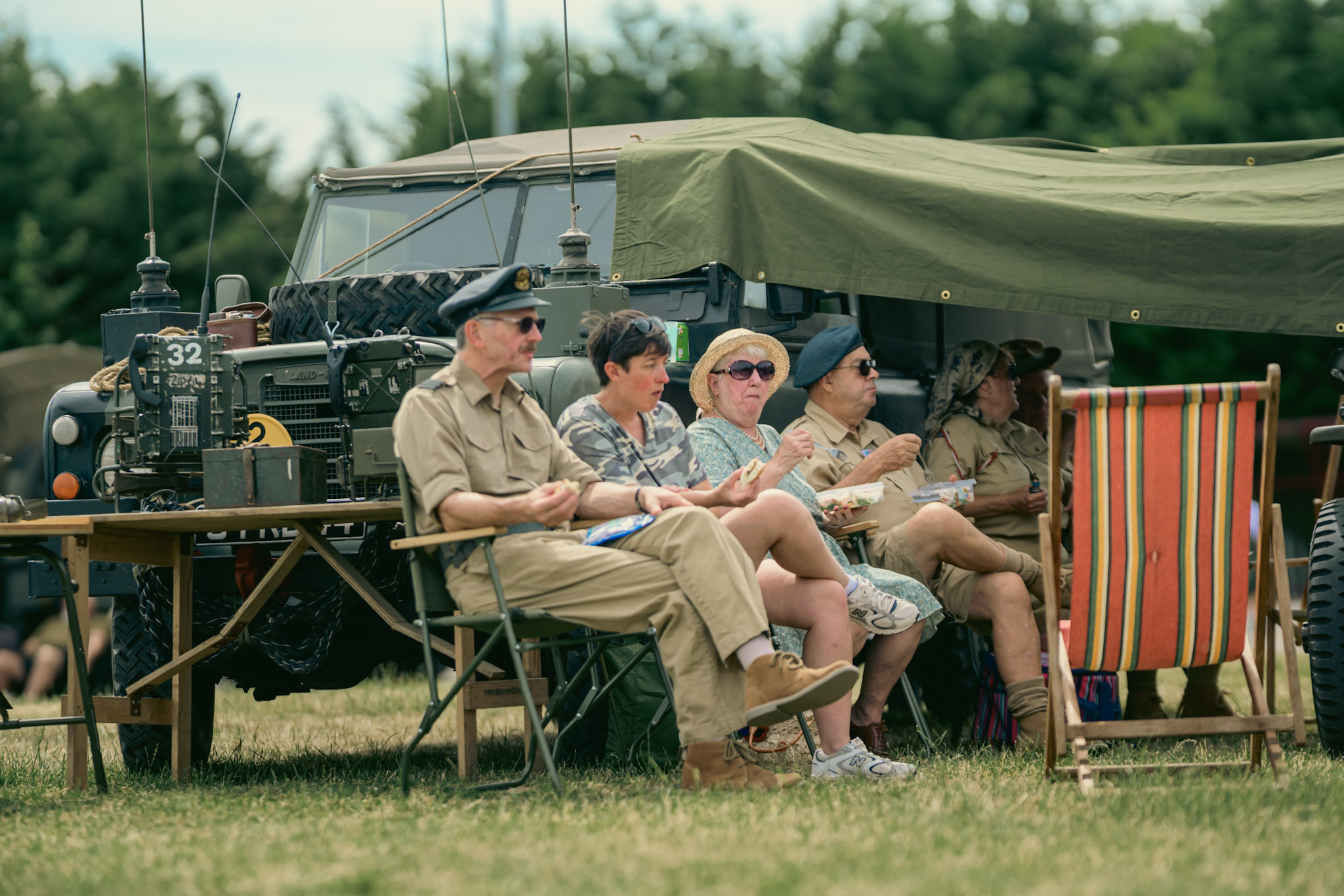 People resting in deckchairs beside a vintage military vehicle at Sleaford 1940s Day