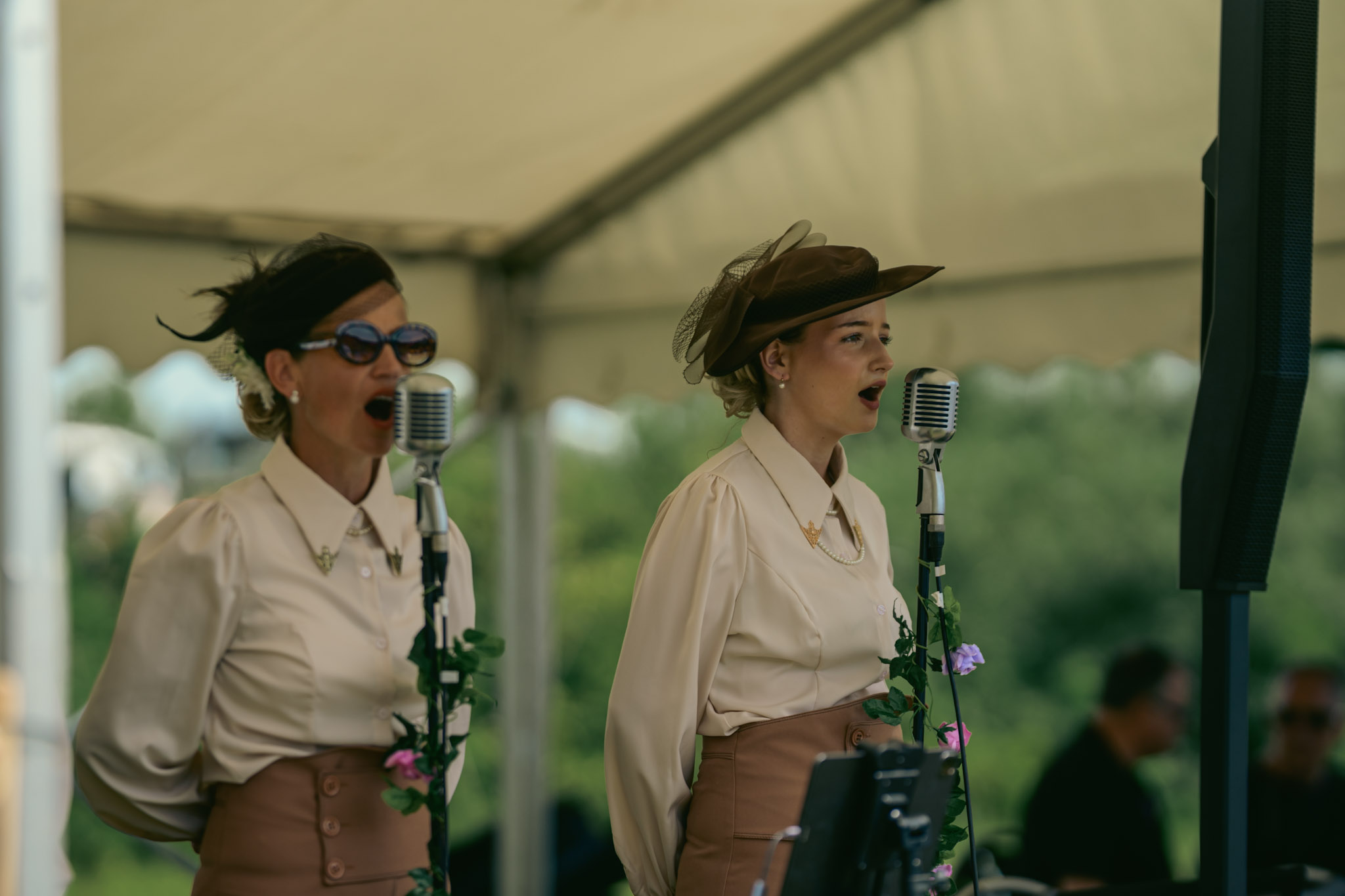 A person in summer event clothing among tents and stalls