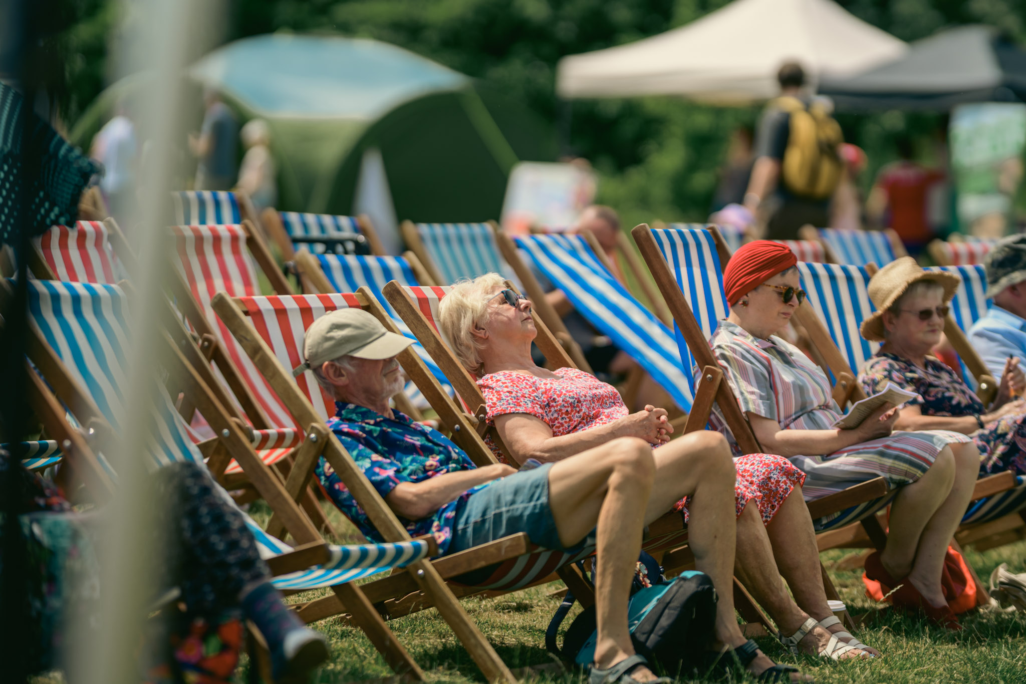 People resting in striped deckchairs at the event