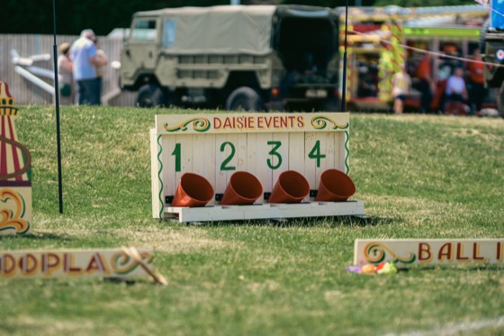 A Daisie Events game stall with numbered red buckets at a 1940s themed event.