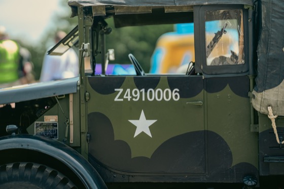 White star and stencilled number on the side of a camouflaged military-style vehicle.