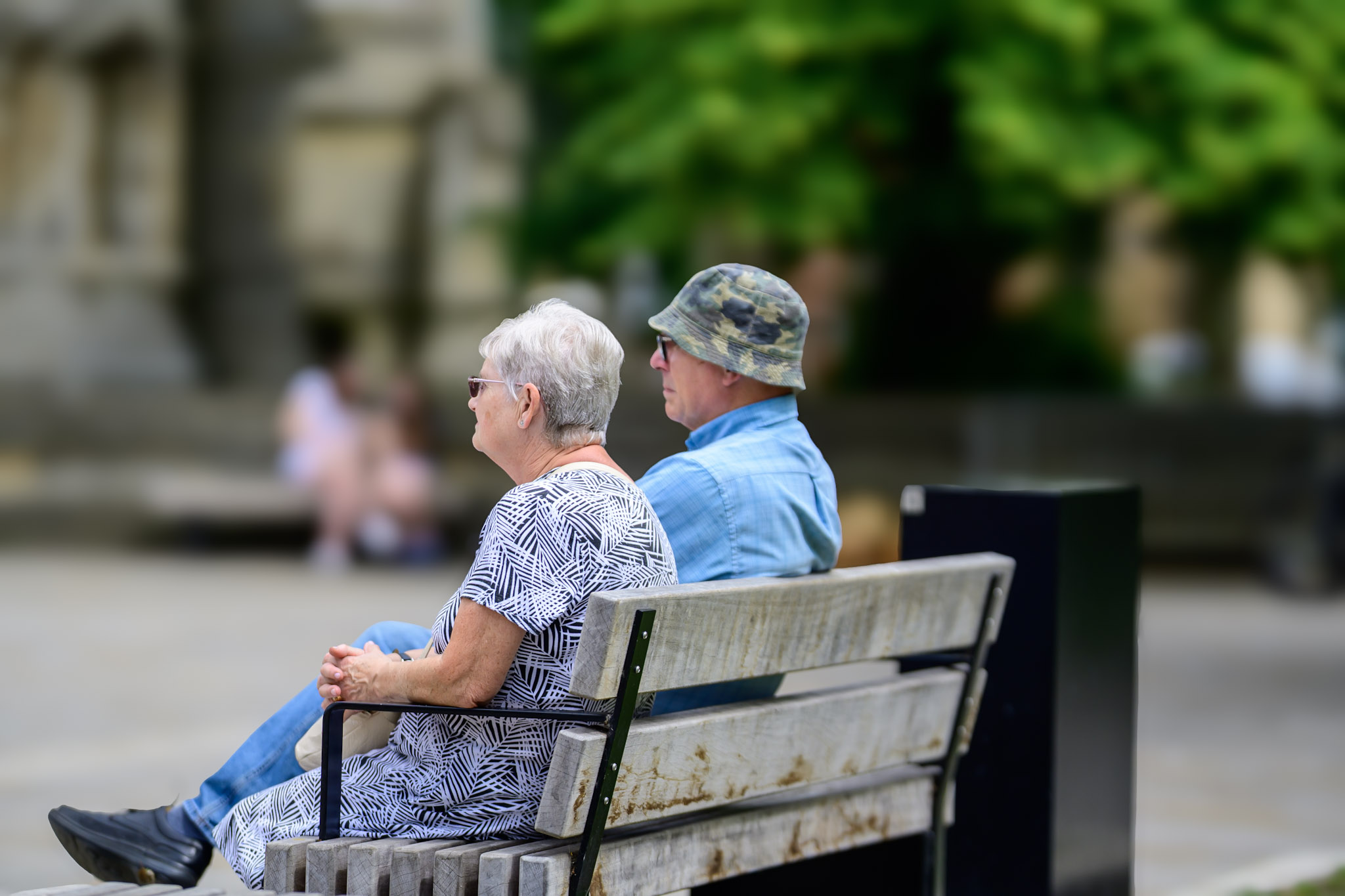 Two people sitting on a bench during Sleaford Midsummer Festival