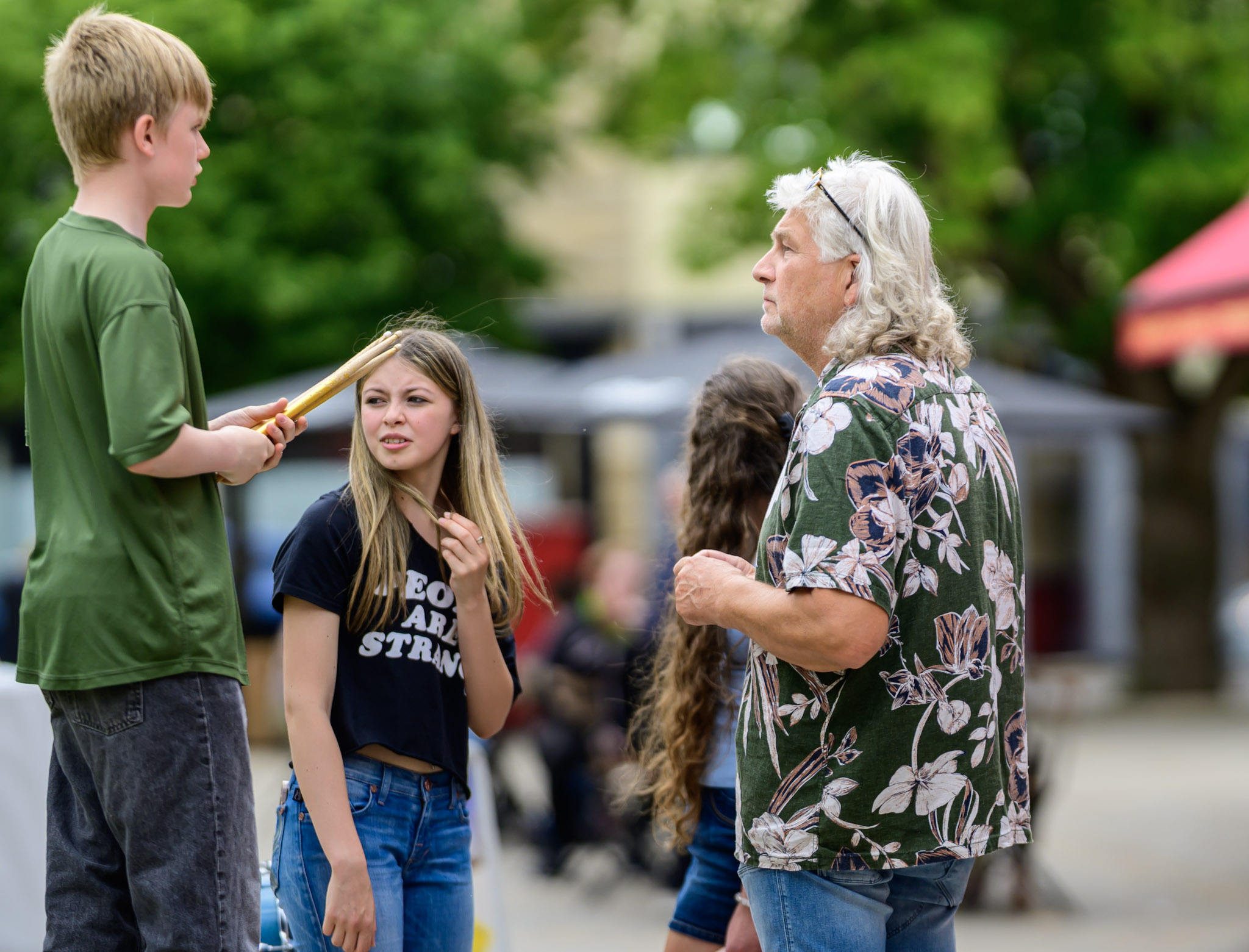 Young people and an older adult talking during the festival