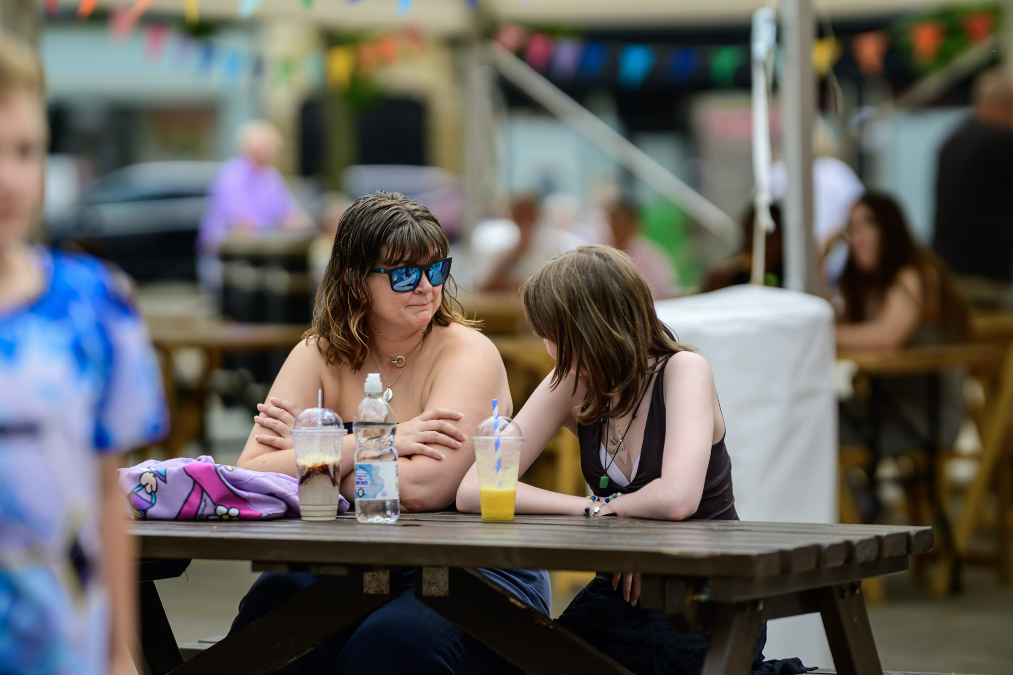 People sitting at a picnic table during the festival