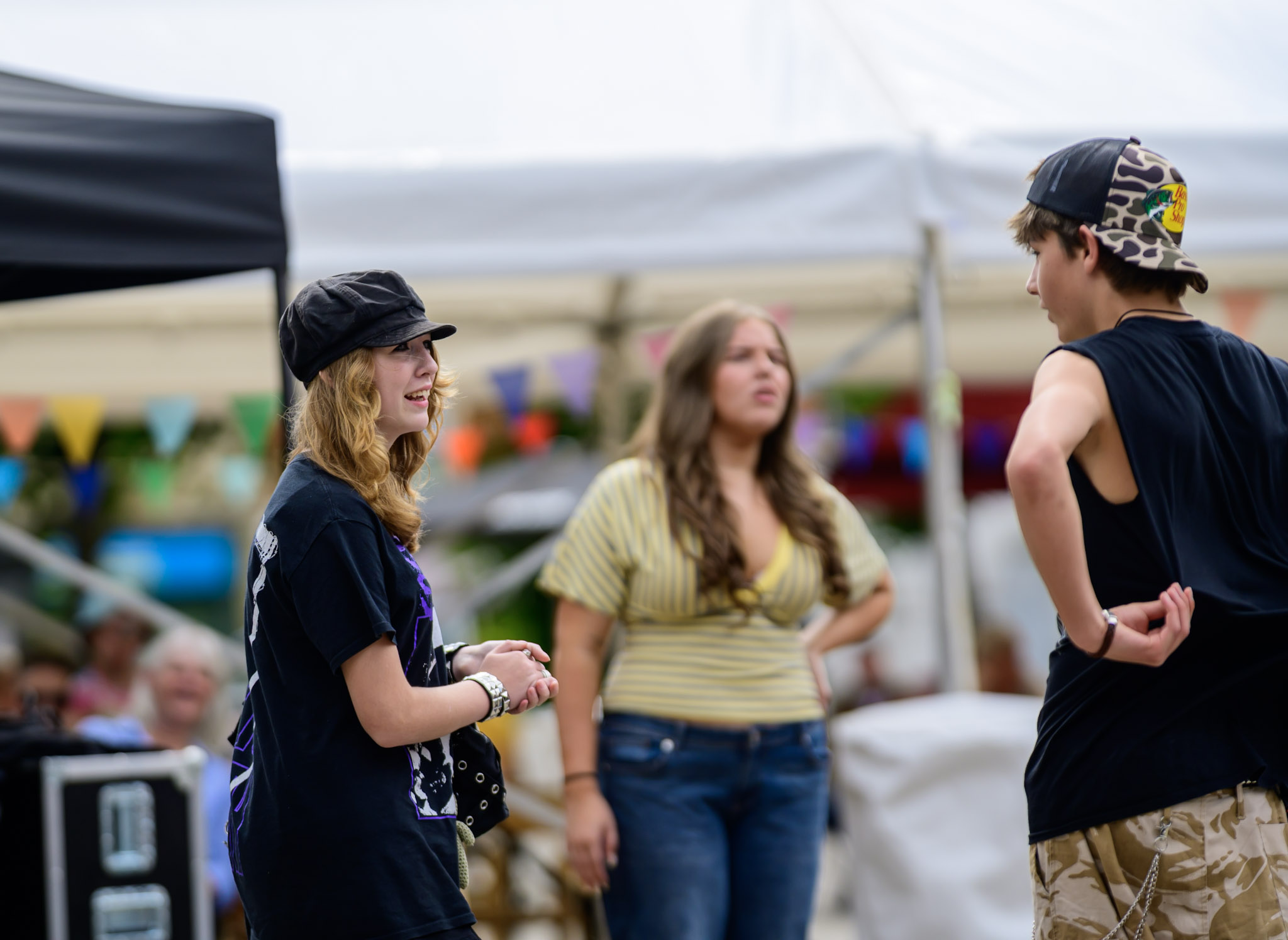 Young performers talking near festival staging