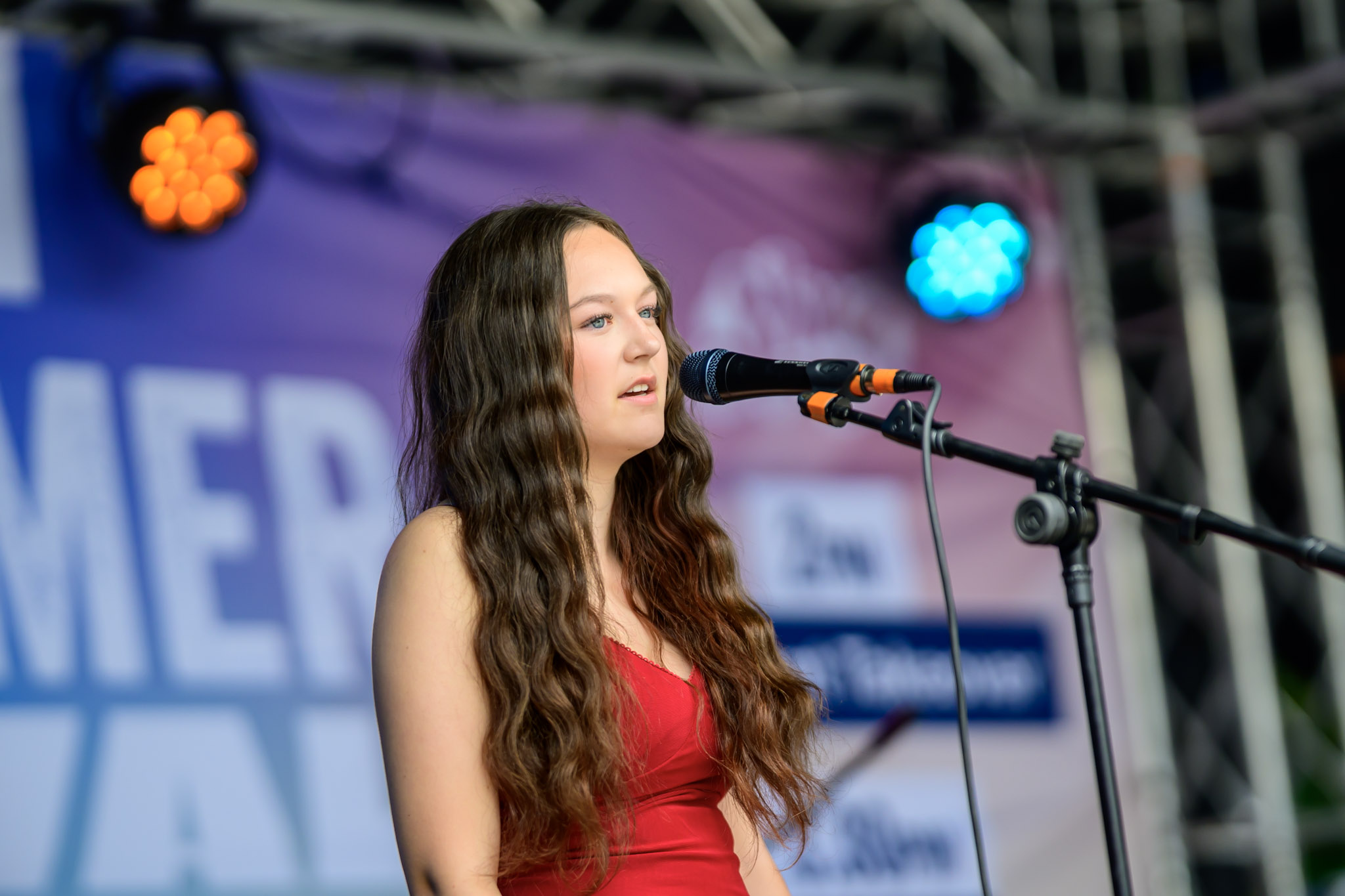 Young singer performing on the festival stage