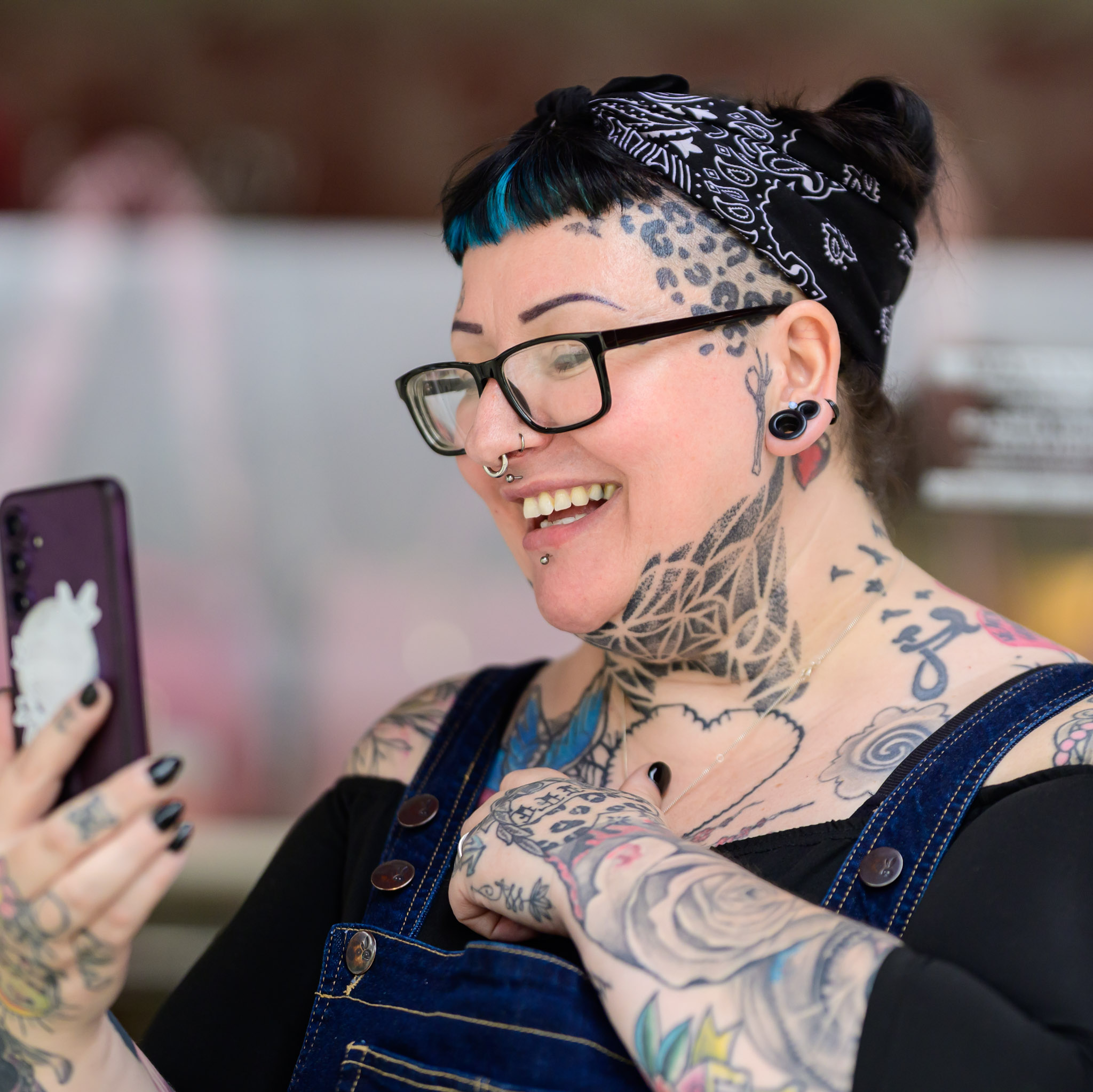 Smiling festival visitor looking at a phone